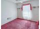 Bright bedroom with floral wallpaper, pink carpet, ceiling fan, and an attached bathroom at 502 Chilt Dr, Brandon, FL 33510