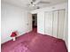 Bright bedroom with a closet, ceiling fan, and pink carpet at 502 Chilt Dr, Brandon, FL 33510