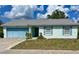 Lovely single-story home with blue garage door, white framed windows and trimmed bushes at 502 Chilt Dr, Brandon, FL 33510