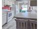 Kitchen area with breakfast bar seating, floral wallpaper, and plenty of natural light at 502 Chilt Dr, Brandon, FL 33510