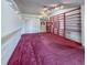 Bright room with long floating shelves, built-in shelving, and a front door with double closets at 502 Chilt Dr, Brandon, FL 33510