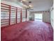 Spacious living room with vaulted ceiling, built-in shelving, and sliding glass doors to outdoors at 502 Chilt Dr, Brandon, FL 33510