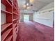 Bright living room featuring unique built-in shelving, ceiling fan, and sliding glass door access at 502 Chilt Dr, Brandon, FL 33510