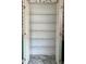Pantry storage with wire racks in a room featuring floral wallpaper and white floors at 502 Chilt Dr, Brandon, FL 33510