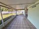Enclosed porch features tiled floors and a view to a spacious backyard with mature trees at 502 Chilt Dr, Brandon, FL 33510