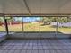 The tiled porch overlooks a serene backyard with views of lush greenery and clear blue skies at 502 Chilt Dr, Brandon, FL 33510