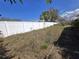 Backyard with overgrown grass and partial fence line at 5031 Billings Dr, Holiday, FL 34690