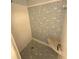 Bathroom shower with light blue and white grid tiled surround and corner seating at 5031 Billings Dr, Holiday, FL 34690