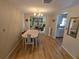 Cozy dining room with chandelier, hardwood floors, and natural light at 5031 Billings Dr, Holiday, FL 34690