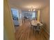 Inviting dining room with hardwood floors leading to a bright living space at 5031 Billings Dr, Holiday, FL 34690