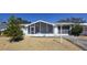 Beautiful home featuring a cozy screened-in porch, attached garage, and desert landscaping at 5031 Billings Dr, Holiday, FL 34690