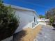 View of home's exterior featuring tan gravel and a partial fence line at 5031 Billings Dr, Holiday, FL 34690
