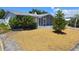 Home exterior featuring front yard and screened in porch at 5031 Billings Dr, Holiday, FL 34690