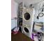 Convenient laundry area with stacked washer and dryer units and a utility sink at 5031 Billings Dr, Holiday, FL 34690