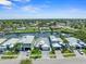This aerial view shows waterfront homes with a canal system, boat docks and lush, green lawns on a sunny day at 574 Bimini Bay Blvd, Apollo Beach, FL 33572