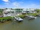 Aerial view of two waterfront homes with private docks, pools, and tiki hut at 574 Bimini Bay Blvd, Apollo Beach, FL 33572