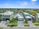 An aerial view shows waterfront homes with lush landscaping, paver driveways and the canal system in the neighborhood at 574 Bimini Bay Blvd, Apollo Beach, FL 33572