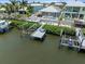 Aerial view of the waterfront property, showcasing the pool, tiki hut, and private dock at 574 Bimini Bay Blvd, Apollo Beach, FL 33572
