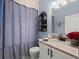 Charming bathroom featuring elegant vanity, a decorative mirror, and a stylish shower curtain, creating a cozy space at 574 Bimini Bay Blvd, Apollo Beach, FL 33572