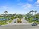 Inviting entrance to a gated community featuring lush landscaping, a serene pond, and controlled access for resident privacy at 574 Bimini Bay Blvd, Apollo Beach, FL 33572