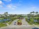 Welcoming entrance to a private community enhanced with palm trees, colorful flower beds, and a secure, gated entry at 574 Bimini Bay Blvd, Apollo Beach, FL 33572