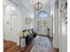 Welcoming entryway with high ceilings, a statement chandelier, and a stylish bench for a great first impression at 574 Bimini Bay Blvd, Apollo Beach, FL 33572