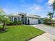 This attractive single-story home features a well manicured green lawn, paver driveway and a two car garage at 574 Bimini Bay Blvd, Apollo Beach, FL 33572