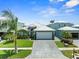 Beautiful single-story home with mature landscaping, a paver driveway, a two-car garage and a lovely exterior at 574 Bimini Bay Blvd, Apollo Beach, FL 33572