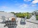 Outdoor fire pit and patio area with gray Adirondack chairs overlooking the canal at 574 Bimini Bay Blvd, Apollo Beach, FL 33572
