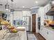 Kitchen showcases stainless steel appliances, marble countertops, and an island with seating at 574 Bimini Bay Blvd, Apollo Beach, FL 33572