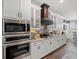 Kitchen features a stainless steel microwave and oven, along with elegant white cabinetry at 574 Bimini Bay Blvd, Apollo Beach, FL 33572