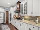 Modern kitchen featuring white cabinets, marble countertops, stainless steel appliances and a decorative wood vent at 574 Bimini Bay Blvd, Apollo Beach, FL 33572