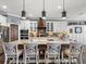 Gourmet kitchen with stainless appliances, marble countertops, large island, and ample seating at 574 Bimini Bay Blvd, Apollo Beach, FL 33572