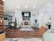 Charming living room featuring stacked stone fireplace with decor and hardwood style flooring at 574 Bimini Bay Blvd, Apollo Beach, FL 33572