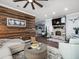 Open concept living room with wood accent wall, fireplace, and hardwood style flooring at 574 Bimini Bay Blvd, Apollo Beach, FL 33572