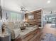 Living room featuring wood accent wall with neutral color palette and lots of natural light at 574 Bimini Bay Blvd, Apollo Beach, FL 33572