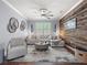 Inviting living room featuring a comfortable sectional couch, accent chair, and wood paneled wall at 574 Bimini Bay Blvd, Apollo Beach, FL 33572