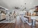 Open floor plan features a dining and kitchen area with white cabinetry and stainless appliances at 574 Bimini Bay Blvd, Apollo Beach, FL 33572