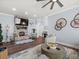 Comfortable living room with stacked stone fireplace and wooden decor features throughout at 574 Bimini Bay Blvd, Apollo Beach, FL 33572