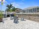 An inviting backyard patio with pavers and chairs surrounding a modern fire pit at 574 Bimini Bay Blvd, Apollo Beach, FL 33572