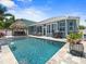 This backyard oasis features a sparkling pool, tiki bar, mature landscaping and plenty of outdoor space at 574 Bimini Bay Blvd, Apollo Beach, FL 33572