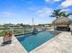 An inviting backyard pool with waterfall and tiki bar provide the perfect setting for relaxation and entertainment at 574 Bimini Bay Blvd, Apollo Beach, FL 33572