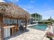 Backyard pool with waterfall and tiki bar offering a great spot for outdoor entertaining and relaxation at 574 Bimini Bay Blvd, Apollo Beach, FL 33572