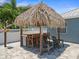 Tiki hut equipped with a bar, grill and seating area near the pool at 574 Bimini Bay Blvd, Apollo Beach, FL 33572