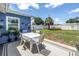 Backyard patio area featuring a table with chairs and landscaped flower beds at 5947 46Th N Ave, Kenneth City, FL 33709