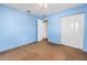 Bedroom with light blue walls, brown carpet, closet with sliding doors, and ceiling fan at 5947 46Th N Ave, Kenneth City, FL 33709