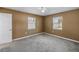 Neutral bedroom with light-colored carpet features ceiling fan, two windows, and neutral paint at 5947 46Th N Ave, Kenneth City, FL 33709