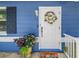 A welcoming front entrance featuring a decorative wreath, potted plants, and a charming welcome mat at 5947 46Th N Ave, Kenneth City, FL 33709