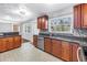 Updated kitchen boasts granite countertops, stainless steel appliances, custom cabinets and designer tile floors at 5947 46Th N Ave, Kenneth City, FL 33709