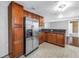 Updated kitchen includes stainless steel refrigerator, granite countertops and an abundance of wood cabinets at 5947 46Th N Ave, Kenneth City, FL 33709